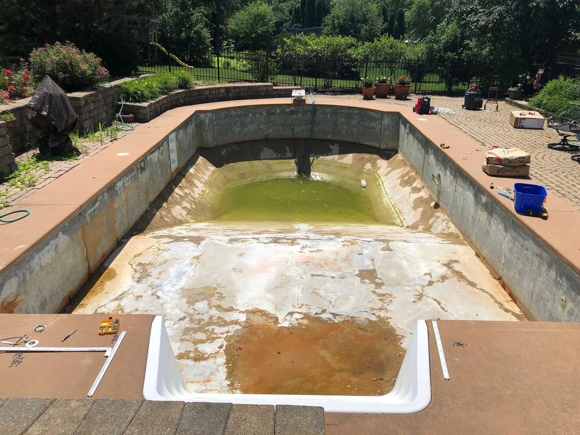 In-ground pool under construction with the shell and plumbing exposed